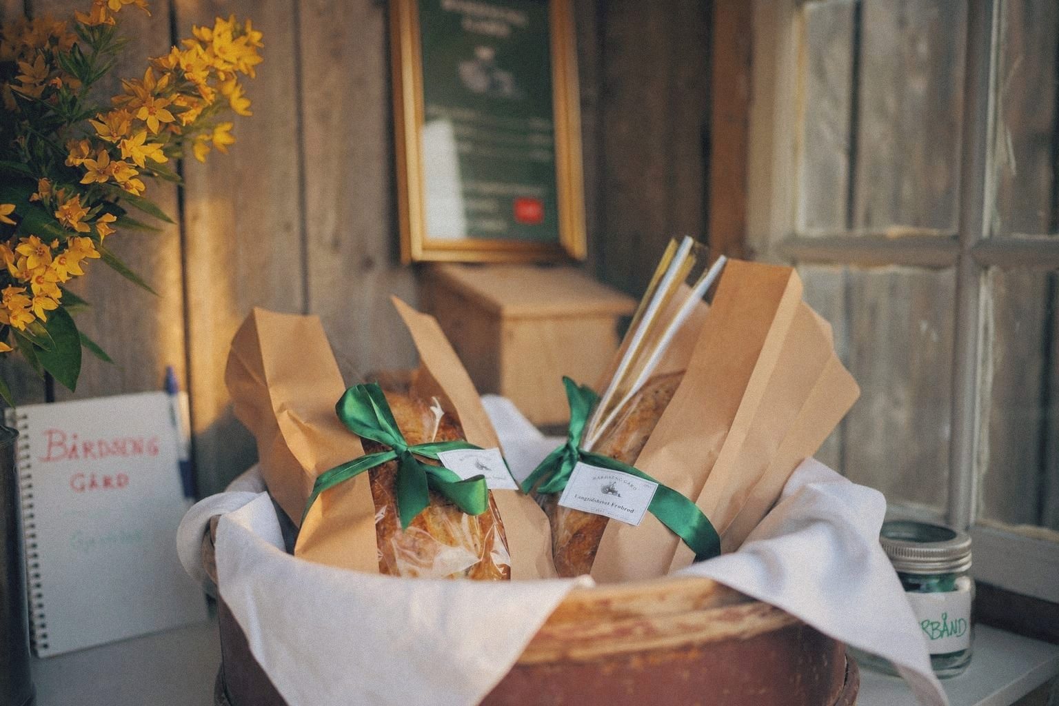 Rustic loaves of farm bread on the wooden counter of the farmstand.